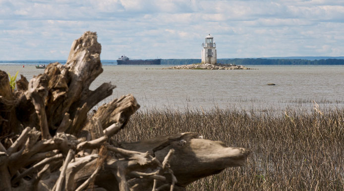 Ship in the waterway near a lighthouse at Lake Saint-Pierre